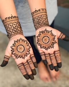 Palm mehndi design featuring a central mandala