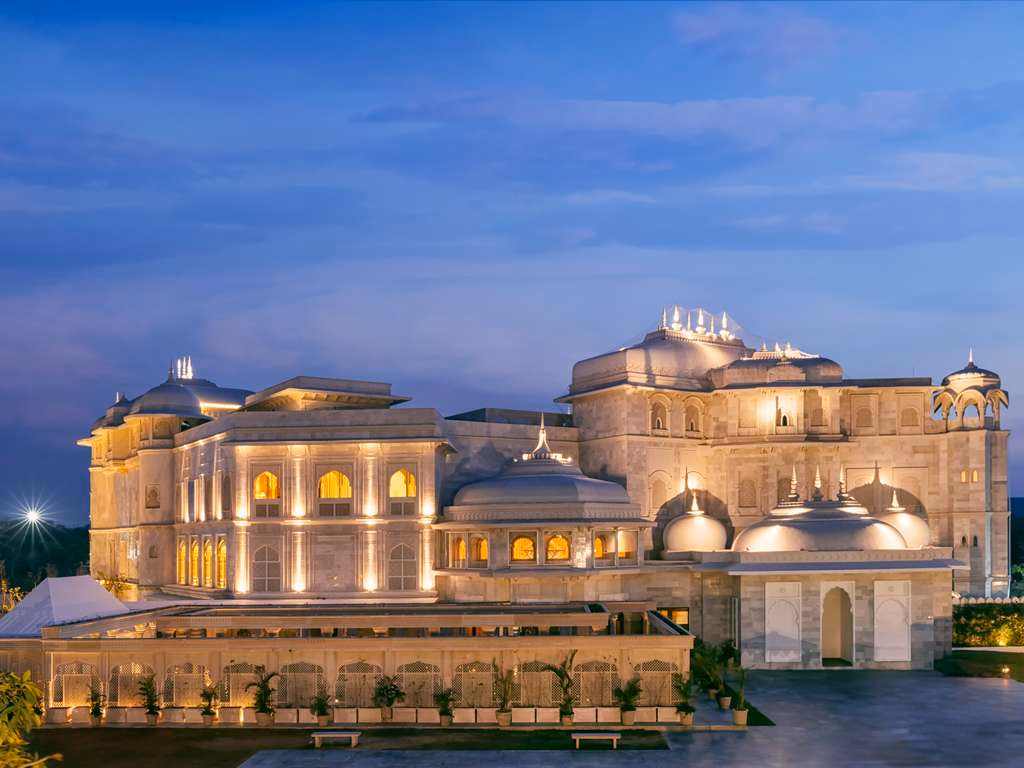 Illuminated marble palace wedding venue in Jaipur at dusk