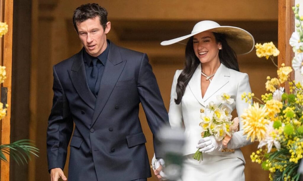 Callum Turner in custom navy double breasted Ferragamo suit at his wedding to Dua Lipa in London