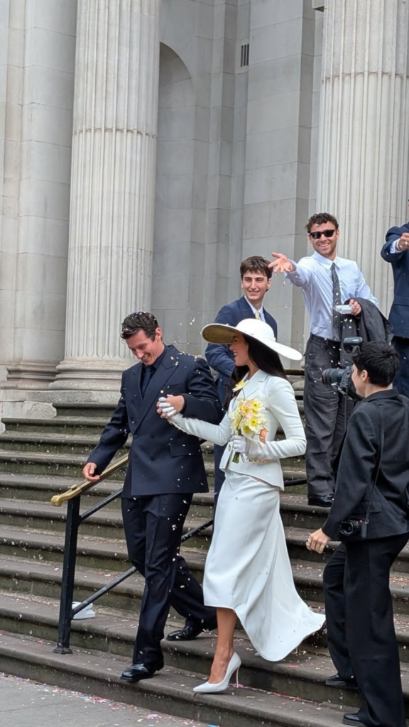 Dua Lipa and Callum Turner walking down the steps of Old Marylebone Town Hall after their wedding on May 31 2026