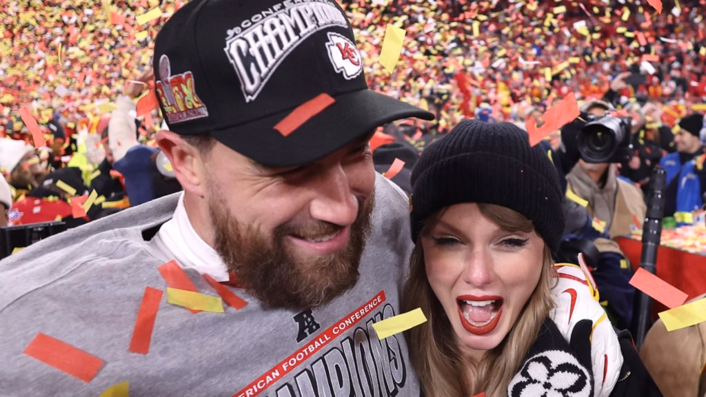 Travis Kelce and Taylor Swift celebrating at a Kansas City Chiefs game

